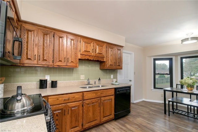 1238 Grenadier Dr, Chesapeake, VA 23322 - kitchen with black appliances, light countertops, brown cabinets, and tasteful backsplash