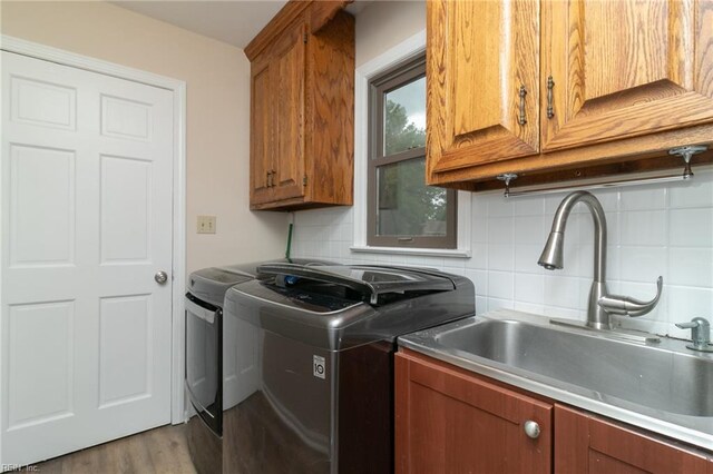 1238 Grenadier Dr, Chesapeake, VA 23322 - washroom featuring cabinet space, washing machine and clothes dryer, and light wood finished floors
