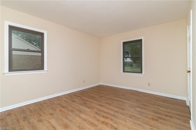 1238 Grenadier Dr, Chesapeake, VA 23322 - spare room featuring light wood finished floors, healthy amount of natural light, and baseboards