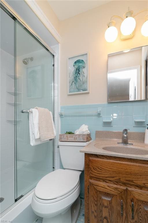 1238 Grenadier Dr, Chesapeake, VA 23322 - full bathroom with vanity, toilet, a stall shower, tile walls, and wainscoting