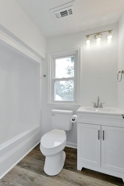 4401 Southampton Arch, Portsmouth, VA 23703 - bathroom with toilet, vanity, wood finished floors, baseboards, and shower / washtub combination