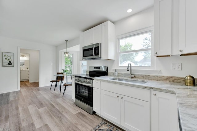 4401 Southampton Arch, Portsmouth, VA 23703 - kitchen with stainless steel appliances, a sink, plenty of natural light, and white cabinets