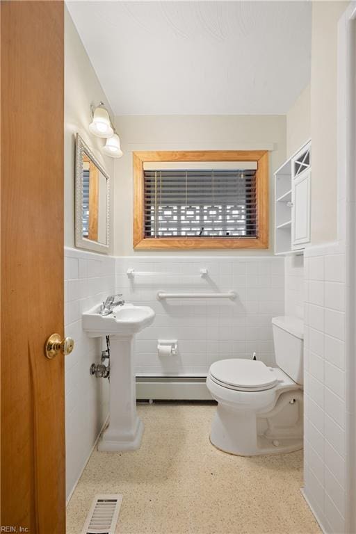 34 Kenwood Dr, Hampton, VA 23666 - bathroom with baseboard heating, tile walls, toilet, and a wainscoted wall