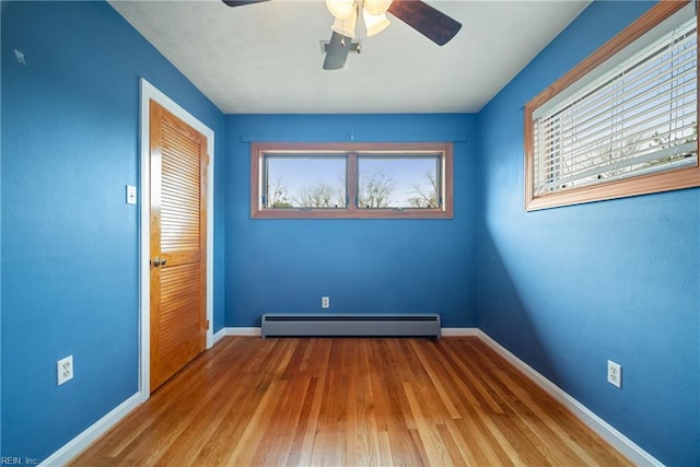 34 Kenwood Dr, Hampton, VA 23666 - unfurnished room with baseboard heating, a ceiling fan, baseboards, and hardwood / wood-style floors