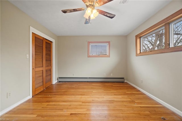 34 Kenwood Dr, Hampton, VA 23666 - unfurnished bedroom with a baseboard heating unit, multiple windows, baseboards, and light wood-type flooring