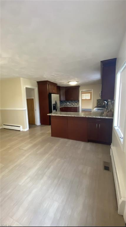 34 Kenwood Dr, Hampton, VA 23666 - kitchen with stainless steel fridge with ice dispenser, a baseboard radiator, a peninsula, a sink, and light wood finished floors