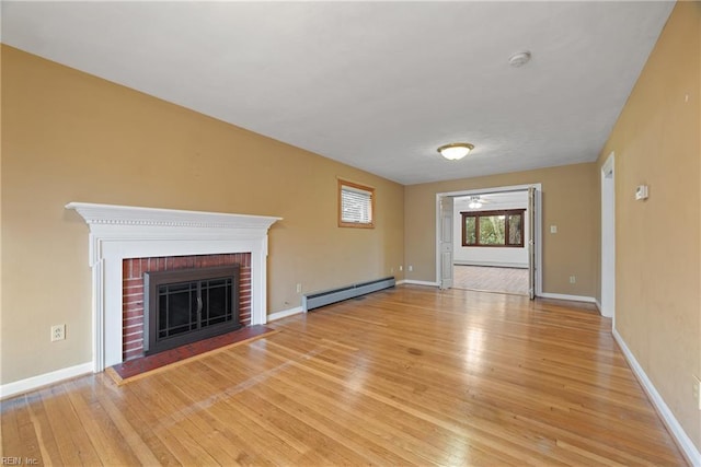 34 Kenwood Dr, Hampton, VA 23666 - unfurnished living room featuring baseboard heating, light wood-style floors, a baseboard radiator, and a fireplace