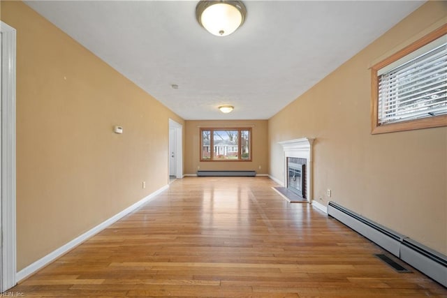 34 Kenwood Dr, Hampton, VA 23666 - unfurnished living room featuring baseboard heating, light wood-style flooring, a baseboard heating unit, and a glass covered fireplace