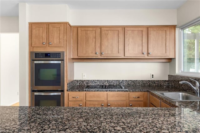 4249 Cheswick Ln, Virginia Beach, VA 23455 - kitchen featuring stainless steel double oven, a sink, black electric cooktop, dark stone counters, and brown cabinets