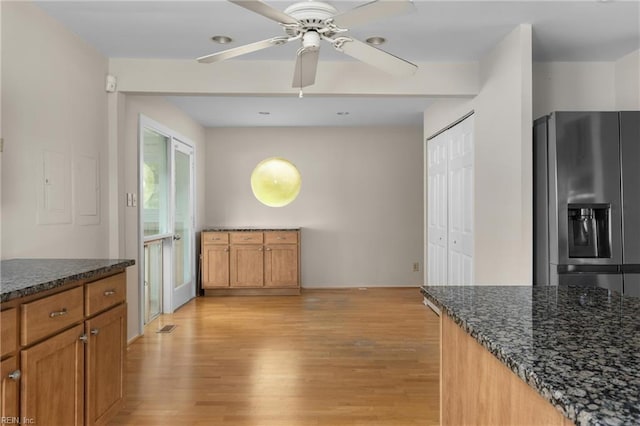 4249 Cheswick Ln, Virginia Beach, VA 23455 - kitchen featuring stainless steel fridge with ice dispenser, dark stone counters, light wood finished floors, a ceiling fan, and brown cabinetry
