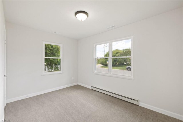 2600 Eastwood Ave, Chesapeake, VA 23324 - carpeted empty room featuring a baseboard heating unit, plenty of natural light, and baseboards