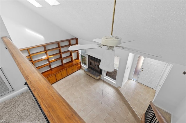 4321 Moosewood Ct, Virginia Beach, VA 23462 - staircase featuring ceiling fan, a skylight, tile patterned flooring, vaulted ceiling, and a fireplace with raised hearth