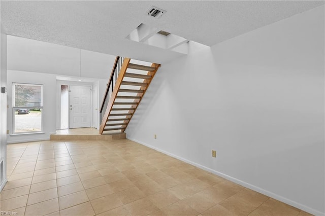 4321 Moosewood Ct, Virginia Beach, VA 23462 - unfurnished living room with baseboards, a textured ceiling, stairs, and light tile patterned flooring