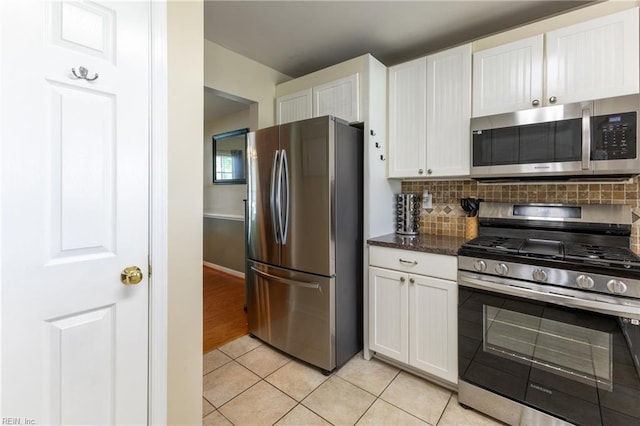 115 Rochdale Ln, Suffolk, VA 23434 - kitchen featuring stainless steel appliances, light tile patterned floors, white cabinets, tasteful backsplash, and baseboards