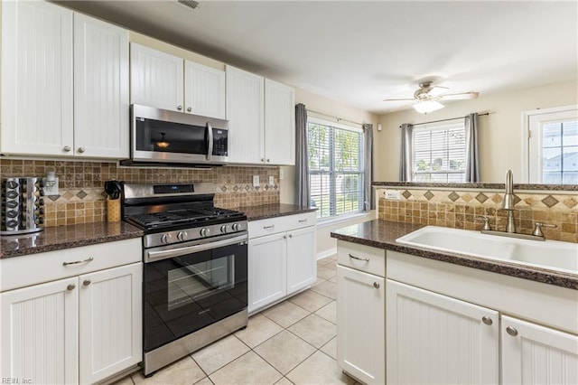 115 Rochdale Ln, Suffolk, VA 23434 - kitchen featuring stainless steel appliances, light tile patterned flooring, a sink, and backsplash