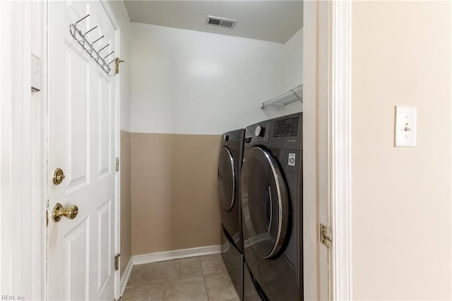 115 Rochdale Ln, Suffolk, VA 23434 - laundry room with washing machine and clothes dryer, light tile patterned floors, and baseboards