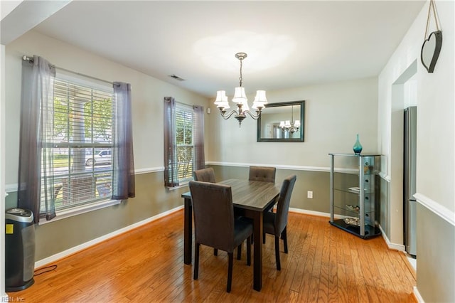 115 Rochdale Ln, Suffolk, VA 23434 - dining area featuring a chandelier, light wood-style flooring, and baseboards