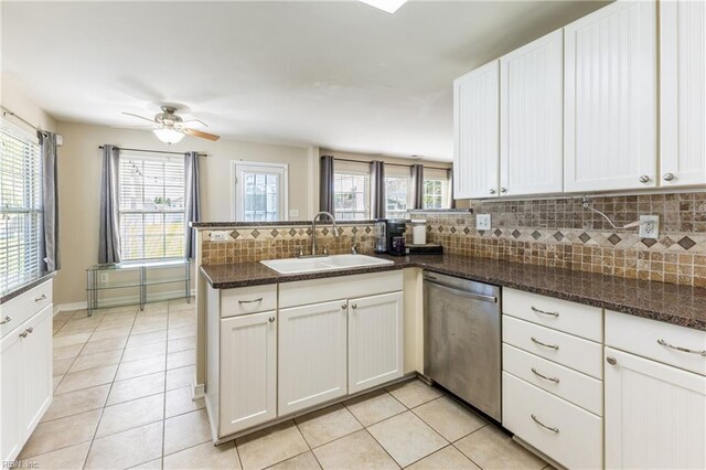 115 Rochdale Ln, Suffolk, VA 23434 - kitchen with dishwasher, a sink, a peninsula, decorative backsplash, and white cabinetry