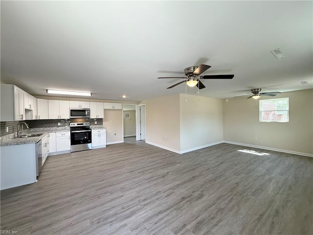 2218 Andrews Blvd, Hampton, VA 23663 - kitchen with stainless steel appliances, a sink, a ceiling fan, white cabinets, and light wood-style floors