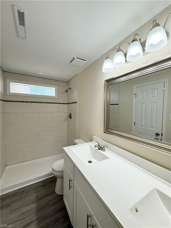 2218 Andrews Blvd, Hampton, VA 23663 - bathroom with toilet, a tile shower, vanity, and wood finished floors