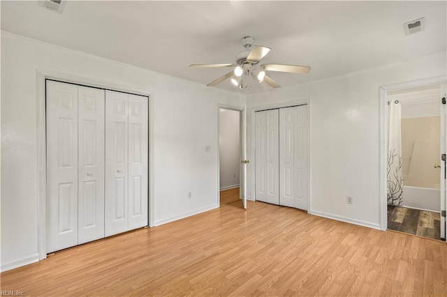 5036 John St, Chesapeake, VA 23321 - unfurnished bedroom featuring multiple closets, light wood finished floors, baseboards, connected bathroom, and ceiling fan