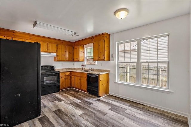 5036 John St, Chesapeake, VA 23321 - kitchen with black appliances, under cabinet range hood, light countertops, and dark wood-style floors