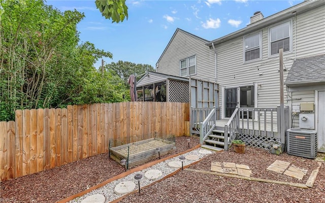 306 San Roman Dr, Chesapeake, VA 23322 - rear view of property featuring central AC unit, a garden, a wooden deck, a chimney, and a sunroom