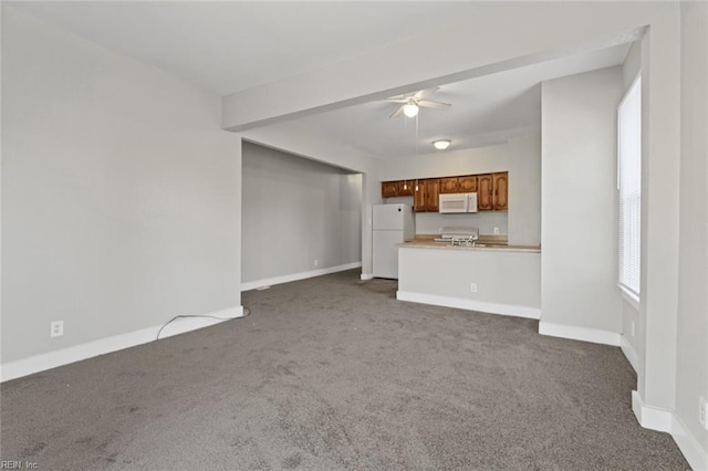3120 Tidewater Dr, Norfolk, VA 23509 - unfurnished living room featuring dark carpet, a ceiling fan, and baseboards