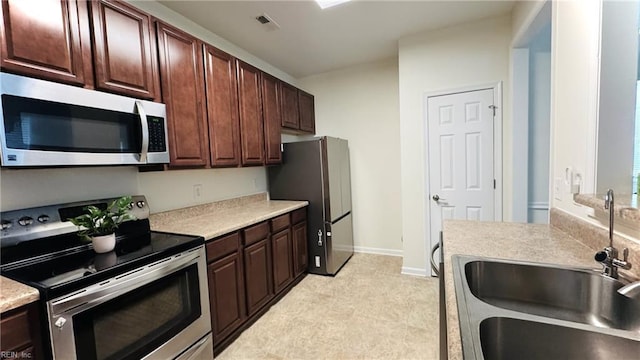1107 Halton Ln, Chesapeake, VA 23320 - kitchen with stainless steel appliances, a sink, light countertops, dark brown cabinets, and baseboards
