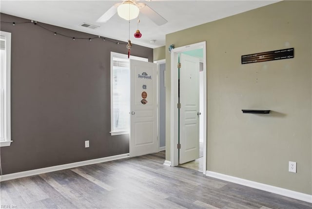 6412 Dove St, Norfolk, VA 23513 - unfurnished bedroom with wood finished floors, baseboards, and a ceiling fan