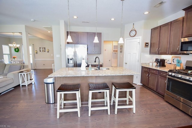 205 Markham St, Suffolk, VA 23435 - kitchen with appliances with stainless steel finishes, a sink, a breakfast bar, dark wood-type flooring, and light stone counters