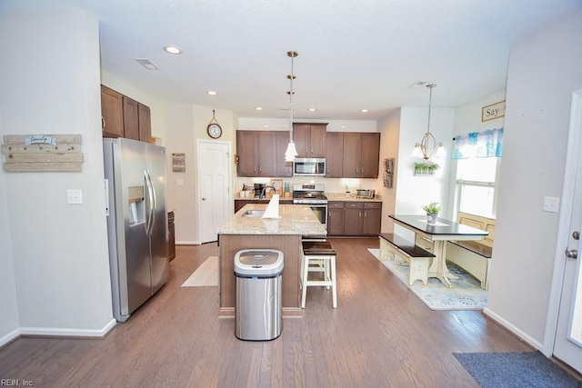 205 Markham St, Suffolk, VA 23435 - kitchen featuring stainless steel appliances, a sink, dark wood-style flooring, a kitchen bar, and a center island