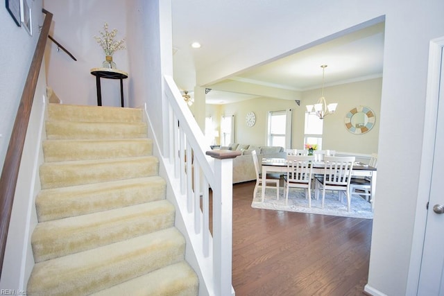 205 Markham St, Suffolk, VA 23435 - stairs featuring wood finished floors, a chandelier, crown molding, and recessed lighting
