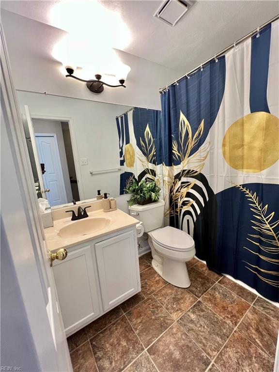 728 S Lake Cir, Chesapeake, VA 23322 - bathroom featuring toilet, vanity, stone finish floors, and a shower with curtain