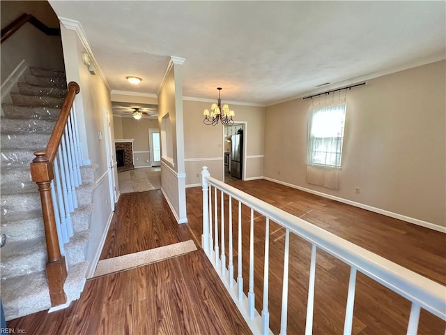 728 S Lake Cir, Chesapeake, VA 23322 - hall featuring wood finished floors, crown molding, stairs, a chandelier, and baseboards