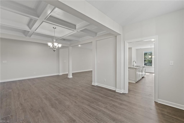 143 Highland Pony Dr, Hertford, NC 27944 - unfurnished living room with a chandelier, dark wood-style flooring, a sink, beam ceiling, and baseboards