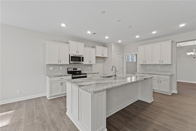 143 Highland Pony Dr, Hertford, NC 27944 - kitchen featuring appliances with stainless steel finishes, a sink, backsplash, wood finished floors, and white cabinets
