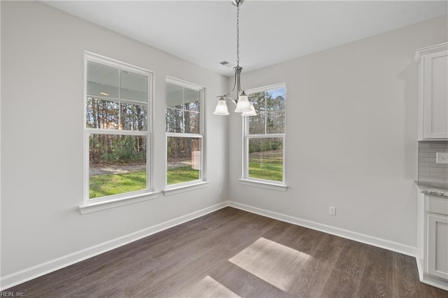 143 Highland Pony Dr, Hertford, NC 27944 - unfurnished dining area with dark wood-style flooring, baseboards, and a chandelier