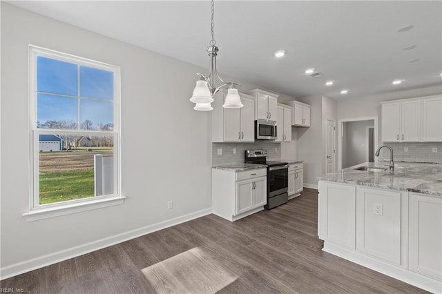 143 Highland Pony Dr, Hertford, NC 27944 - kitchen featuring appliances with stainless steel finishes, a sink, tasteful backsplash, white cabinets, and recessed lighting