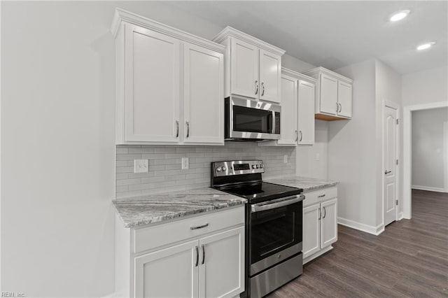 143 Highland Pony Dr, Hertford, NC 27944 - kitchen with appliances with stainless steel finishes, baseboards, white cabinetry, backsplash, and recessed lighting