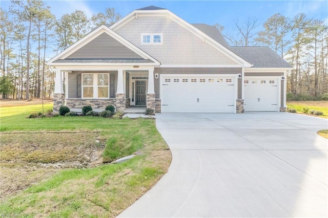 143 Highland Pony Dr, Hertford, NC 27944 - craftsman house with a garage, driveway, stone siding, covered porch, and a front lawn