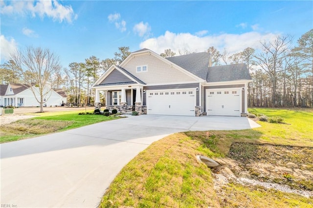 143 Highland Pony Dr, Hertford, NC 27944 - craftsman inspired home with a garage, driveway, a front yard, stone siding, and a porch