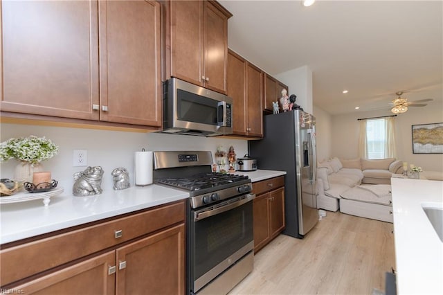 123 Big Woods Dr, Poquoson, VA 23662 - kitchen featuring appliances with stainless steel finishes, open floor plan, light wood-type flooring, light countertops, and recessed lighting