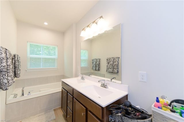 123 Big Woods Dr, Poquoson, VA 23662 - full bath featuring double vanity, a bath, and wood finished floors