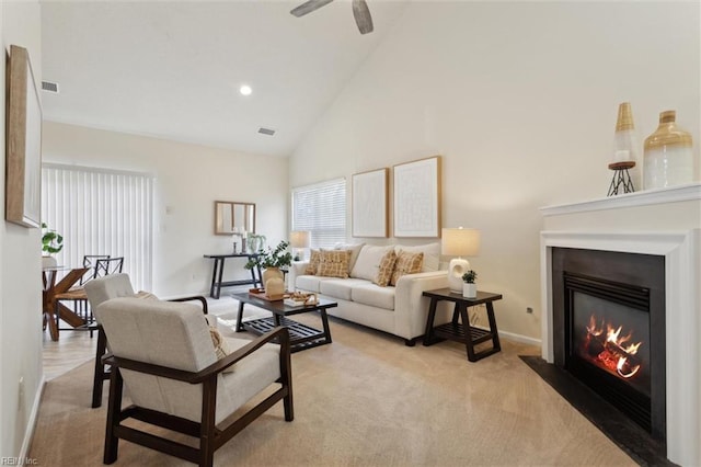 408 Holmes Blvd, Yorktown, VA 23692 - living area featuring a fireplace with flush hearth, high vaulted ceiling, light colored carpet, baseboards, and ceiling fan