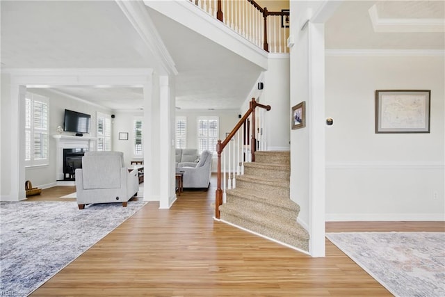 1200 Althea Ct, Chesapeake, VA 23322 - foyer featuring stairs, light wood-type flooring, a glass covered fireplace, crown molding, and baseboards