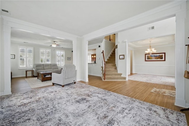 1200 Althea Ct, Chesapeake, VA 23322 - living room with crown molding, wood finished floors, stairway, baseboards, and a chandelier