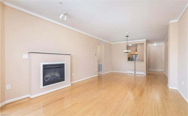 249 W Freemason St Unit 405, Norfolk, VA 23510 - unfurnished living room featuring light wood finished floors, ornamental molding, baseboards, and a fireplace