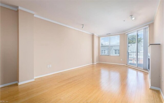 249 W Freemason St Unit 405, Norfolk, VA 23510 - empty room featuring ornamental molding, light wood-style flooring, and baseboards
