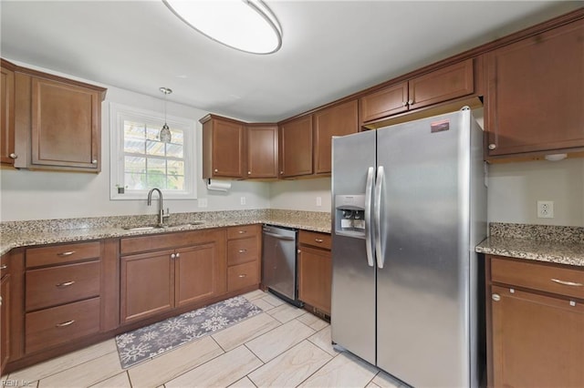 23 Stonewall Ter, Hampton, VA 23666 - kitchen featuring appliances with stainless steel finishes, a sink, brown cabinets, and light stone countertops